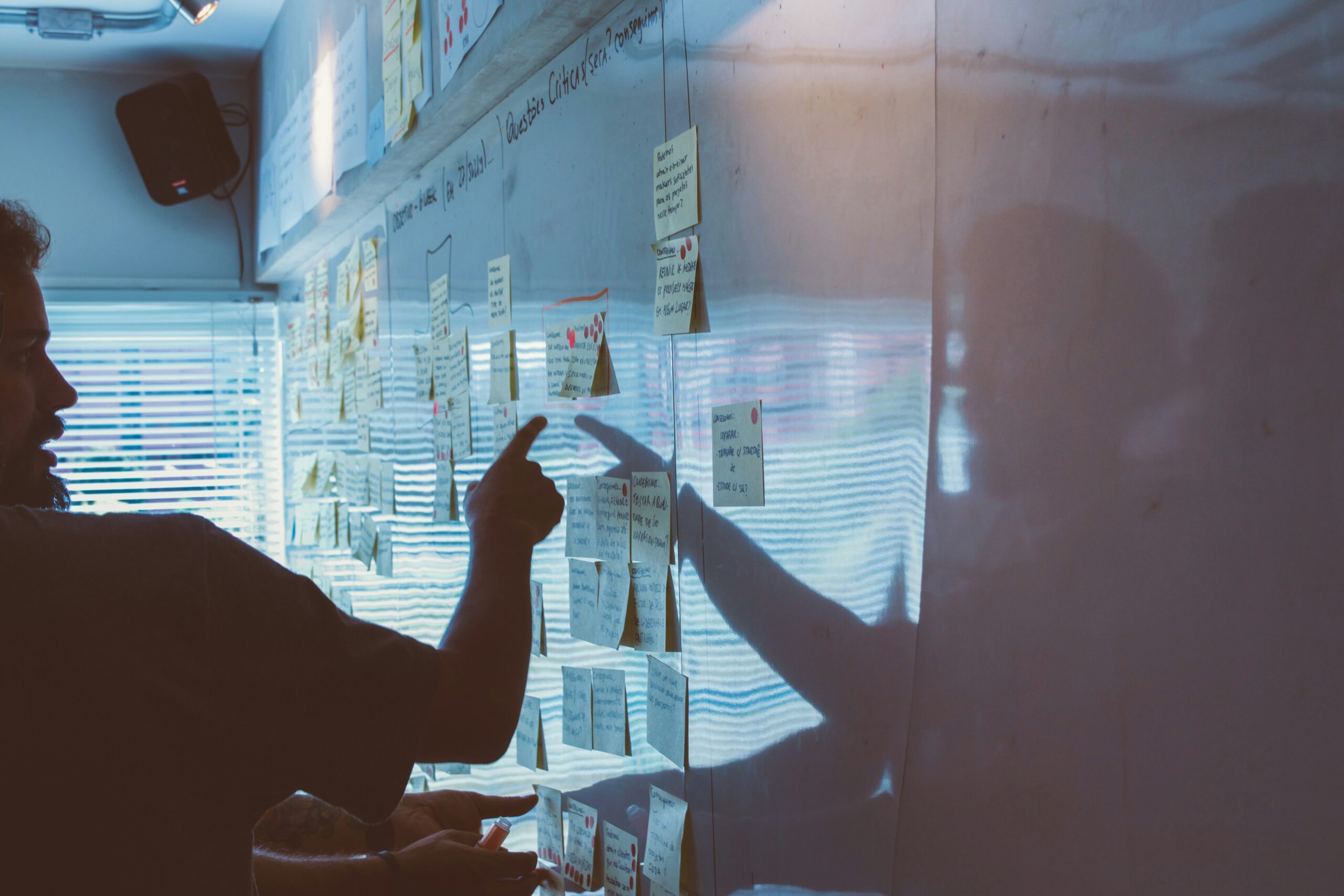 Person reviewing notes on wall